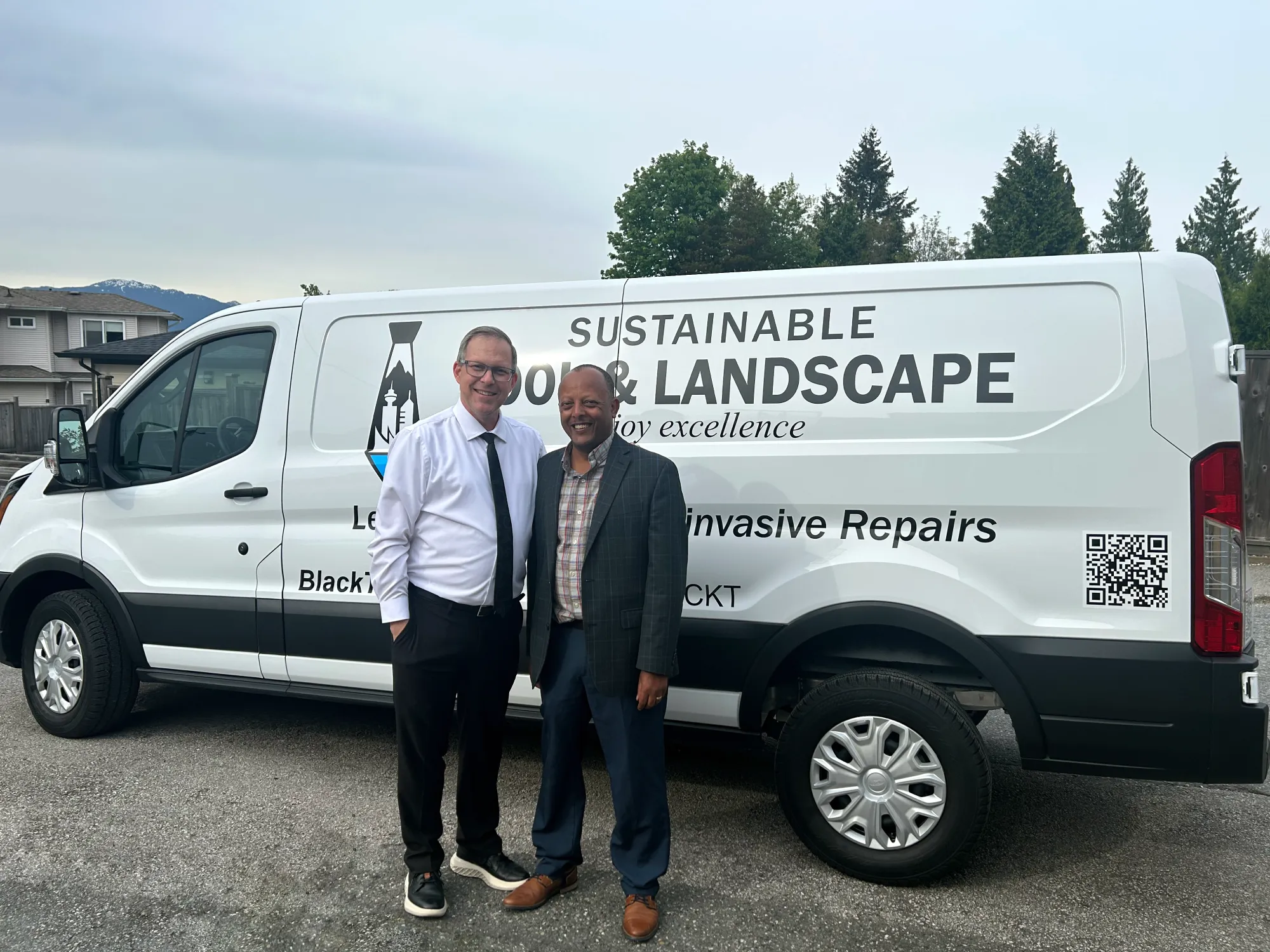 Russell Mackay and his friend Robel from MetroVan Pool Repair in front of a white service van